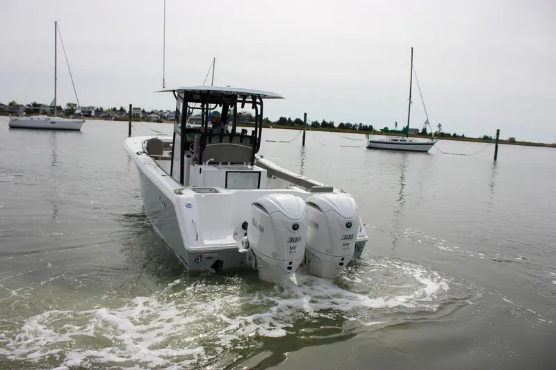 Slide: The Image of 2026 Sea Hunt Gamefish 28 boat with dual engines on calm water. - 68