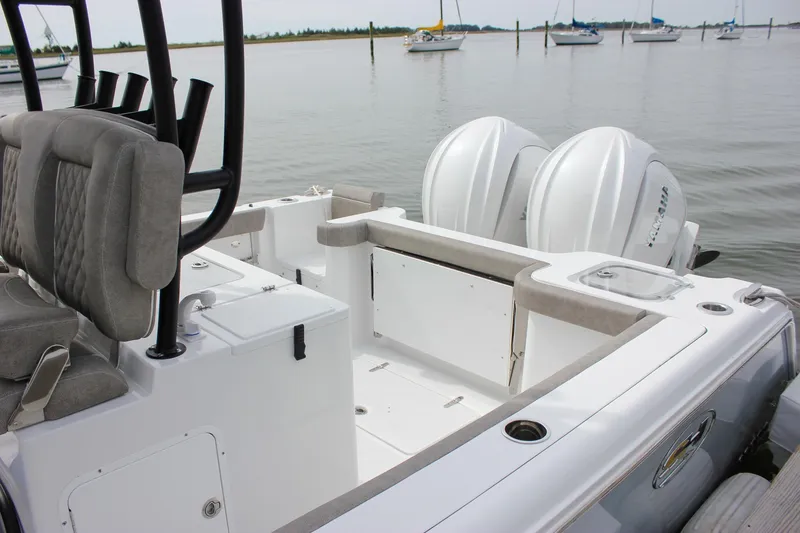 Slide: The Image of 2026 Sea Hunt Gamefish 28 boat with forward seating and dual engines on calm water. - 7