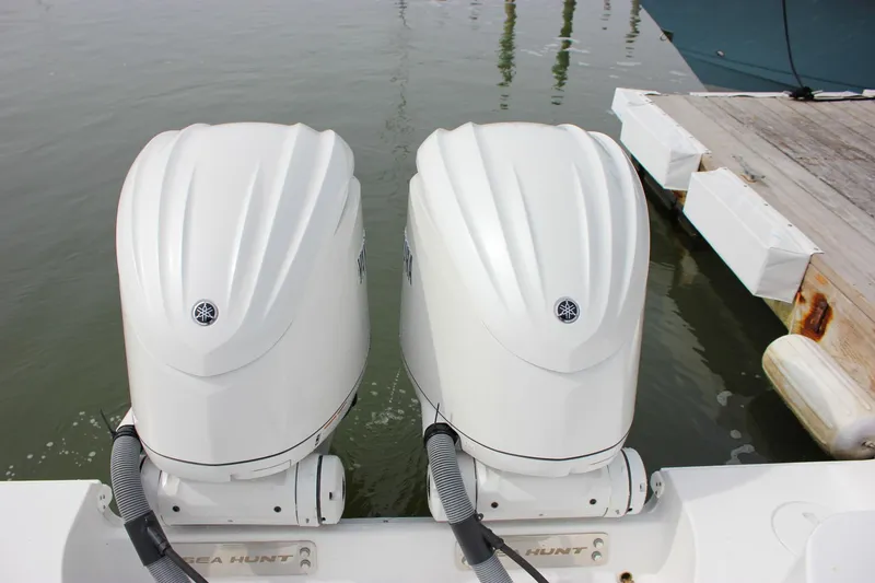 Slide: The Image of Twin outboard engines on a 2026 Sea Hunt Gamefish 28 at a dock. - 75