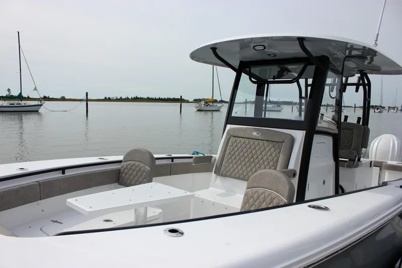 Slide: The Image of 2026 Sea Hunt Gamefish 28 Forward Seating boat with elegant design, docked in a serene marina. - 9