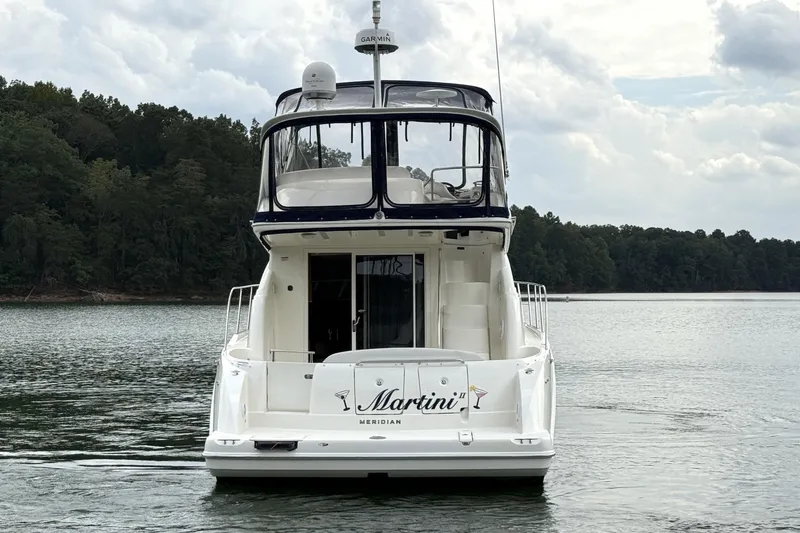Slide: The Image of 2008 Meridian 391 yacht on calm lake with forested shoreline. - 2