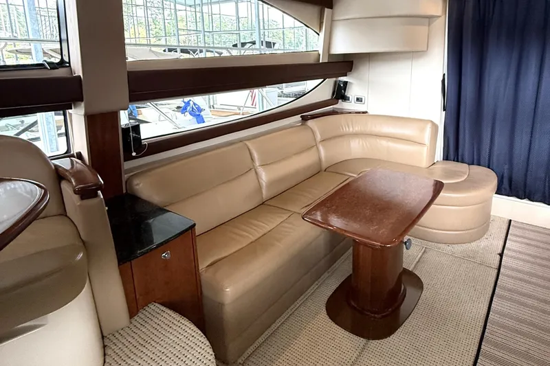 Slide: The Image of Luxurious interior of 2008 Meridian 391 yacht with beige leather seating and wooden table. - 20