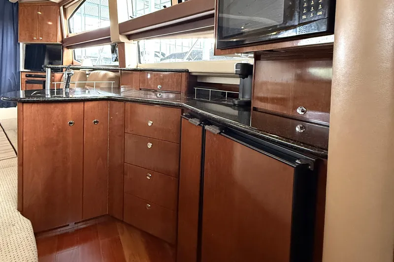 Slide: The Image of Luxurious kitchen interior of 2008 Meridian 391 yacht with wood cabinetry and modern appliances. - 25