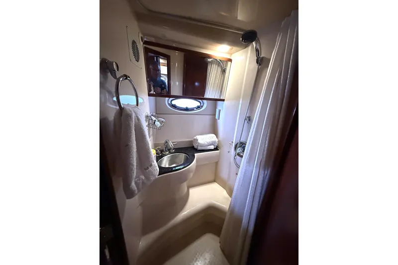 Slide: The Image of Compact bathroom in 2008 Meridian 391 yacht with sink, shower, and porthole window. - 31