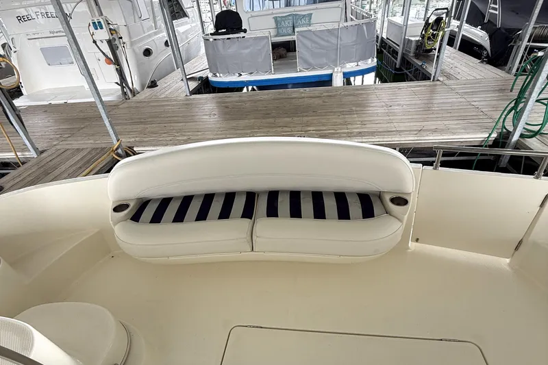 Slide: The Image of 2008 Meridian 391 yacht with striped seating at a marina dock. - 39