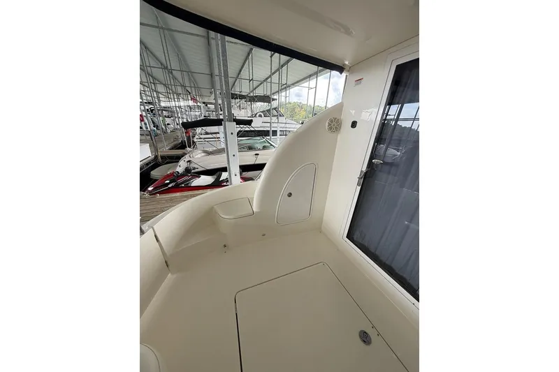 Slide: The Image of 2008 Meridian 391 boat interior with seating area and docked boats in background. - 41