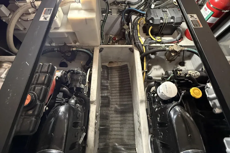 Slide: The Image of Engine compartment of a 2008 Meridian 391 boat, showcasing mechanical components and wiring. - 47