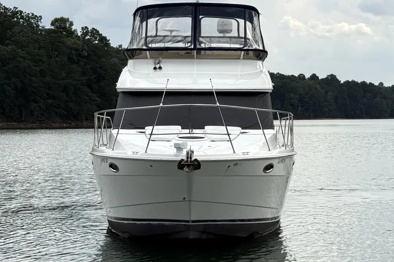 Slide: The Image of 2008 Meridian 391 yacht on calm water, surrounded by lush greenery. - 6