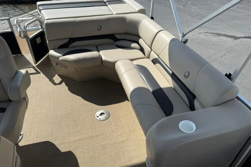Slide: The Image of 2015 Lowe SS 230 pontoon boat interior with beige seating and cup holder. - 12