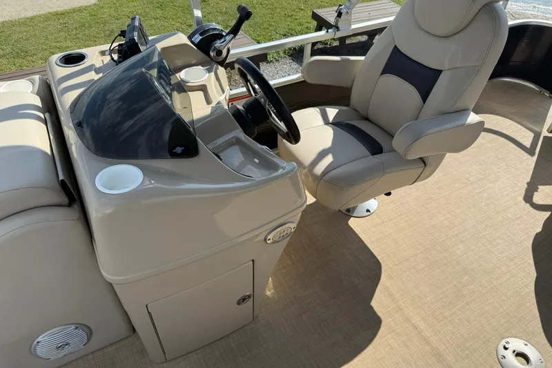 Slide: The Image of 2015 Lowe SS 230 boat interior with steering console and captain's chair. - 13