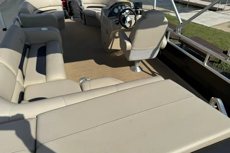 Slide: The Image of 2015 Lowe SS 230 pontoon boat interior with beige seating and steering console. - 18