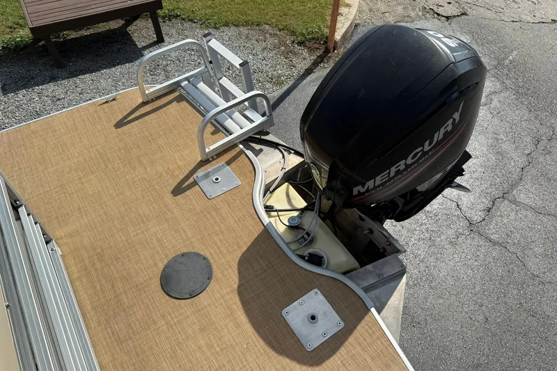 Slide: The Image of 2015 Lowe SS 230 boat with Mercury outboard motor and tan deck. - 19