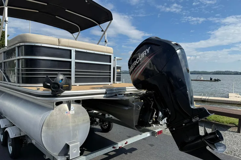 Slide: The Image of 2015 Lowe SS 230 pontoon boat with Mercury outboard motor by a lake. - 3