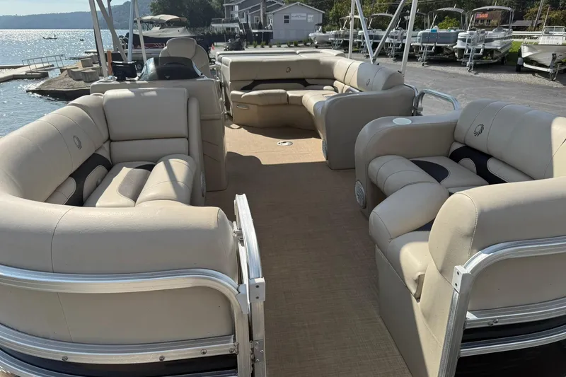 Slide: The Image of 2015 Lowe SS 230 pontoon boat with beige seating, docked by a scenic lake. - 8