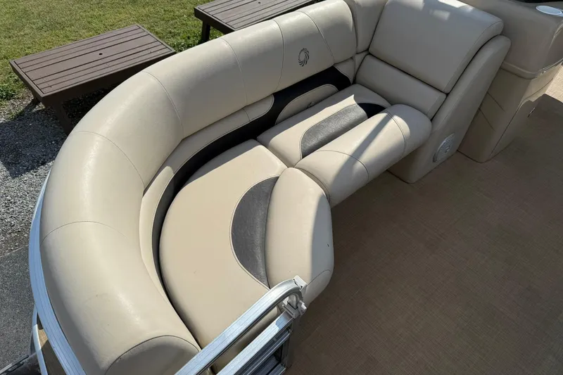 Slide: The Image of Luxurious seating on a 2015 Lowe SS 230 pontoon boat, featuring beige upholstery. - 9