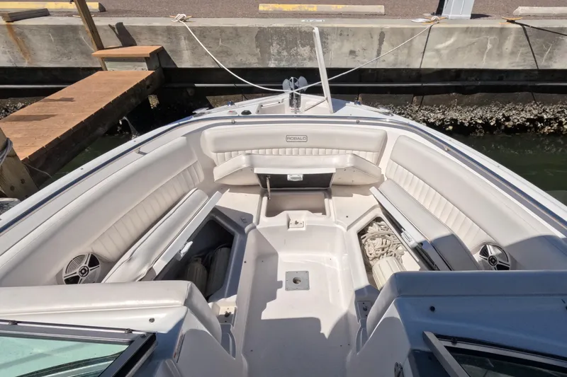 Slide: The Image of 2012 Robalo R247 Dual Console boat interior with white seating and anchor. - 104