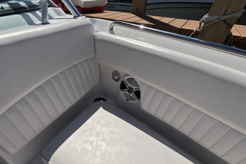 Slide: The Image of 2012 Robalo R247 Dual Console boat interior with seating and storage at dock. - 105