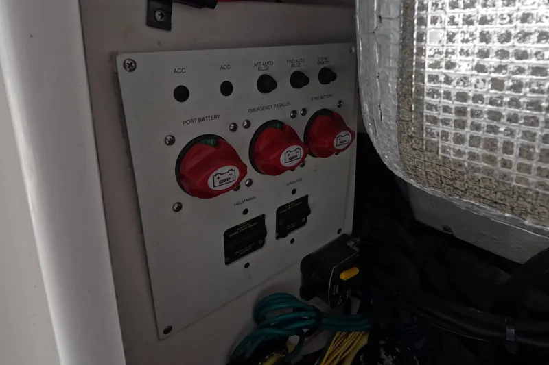 Slide: The Image of 2012 Robalo R247 Dual Console boat with open storage compartment at marina. - 109