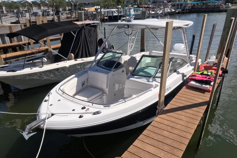 Slide: The Image of 2012 Robalo R247 Dual Console boat docked in marina, sunny day. - 112