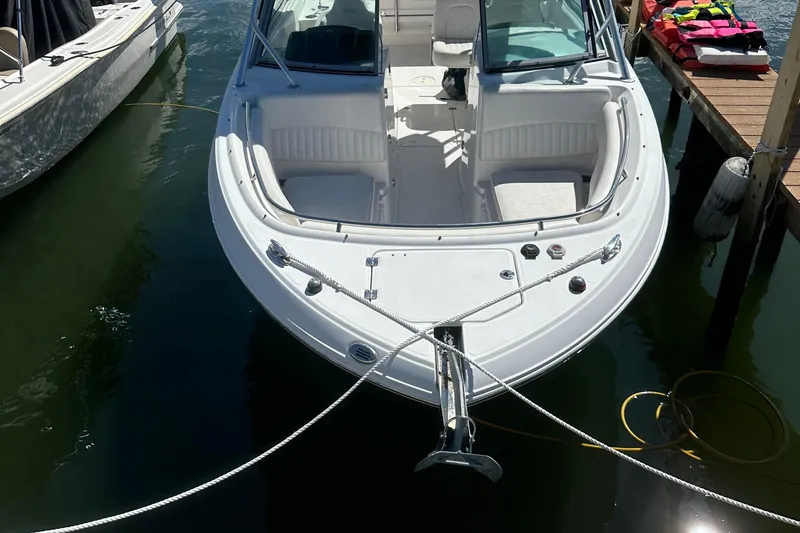 Slide: The Image of 2012 Robalo R247 Dual Console boat docked at marina, sunny day. - 114