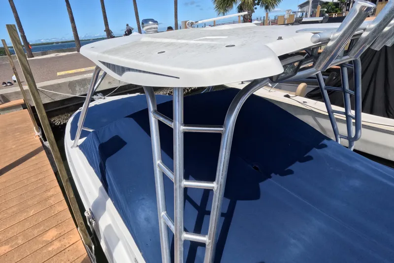 Slide: The Image of 2012 Robalo R247 Dual Console boat with Yamaha engine cover, docked on water. - 120