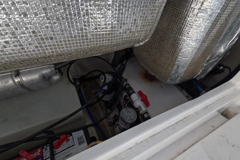 Slide: The Image of 2012 Robalo R247 Dual Console engine compartment with wiring and insulation. - 15