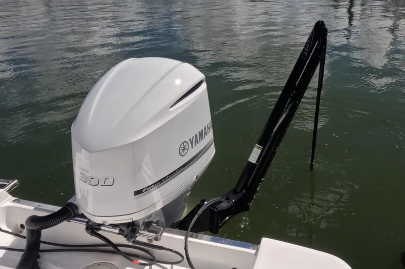 Slide: The Image of 2012 Robalo R247 Dual Console with Yamaha 300 outboard engine on water. - 2