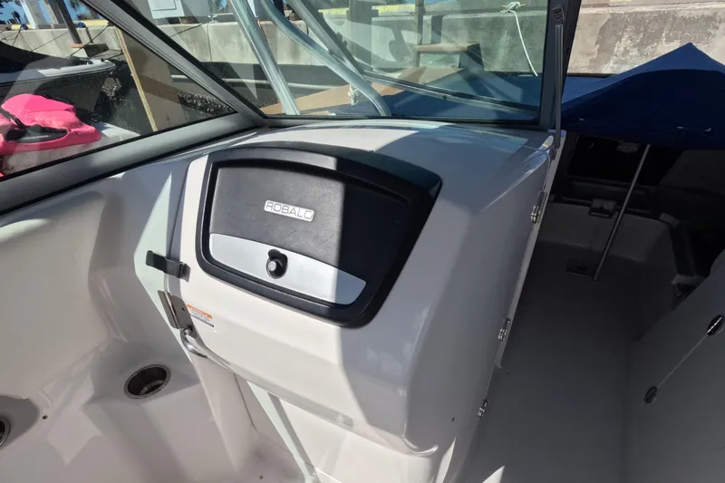 Slide: The Image of 2012 Robalo R247 Dual Console boat interior with storage compartment. - 20