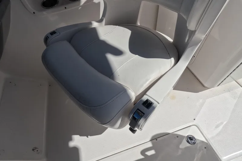 Slide: The Image of 2012 Robalo R247 Dual Console boat seat, white upholstery, adjustable armrest. - 27