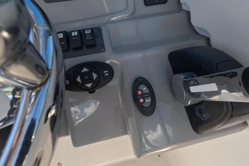 Slide: The Image of 2012 Robalo R247 Dual Console boat controls and steering wheel close-up. - 31