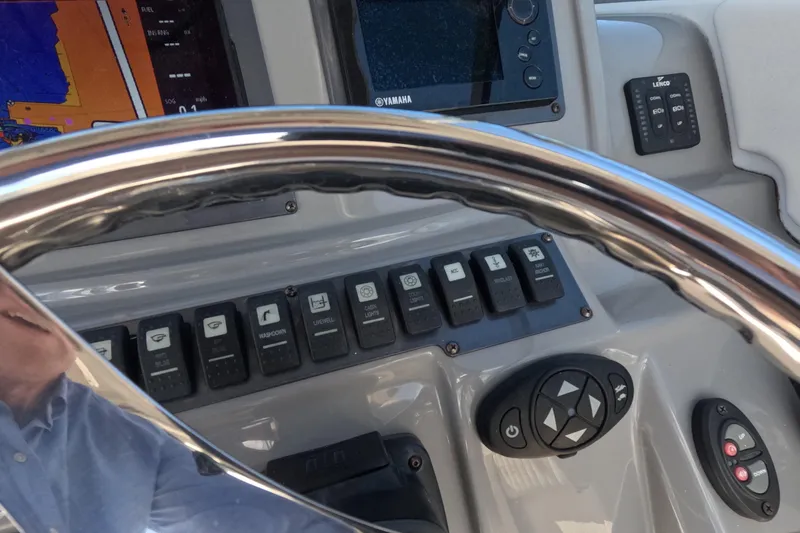 Slide: The Image of 2012 Robalo R247 Dual Console dashboard with steering wheel and control panel. - 32