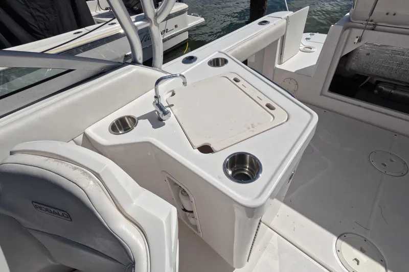 Slide: The Image of 2012 Robalo R247 Dual Console boat interior with sink and cup holders. - 36