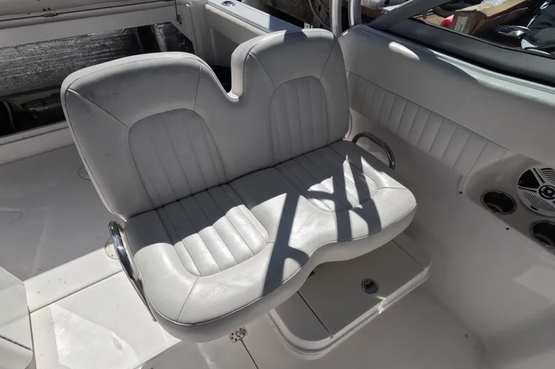 Slide: The Image of 2012 Robalo R247 Dual Console boat interior with white cushioned seating. - 40