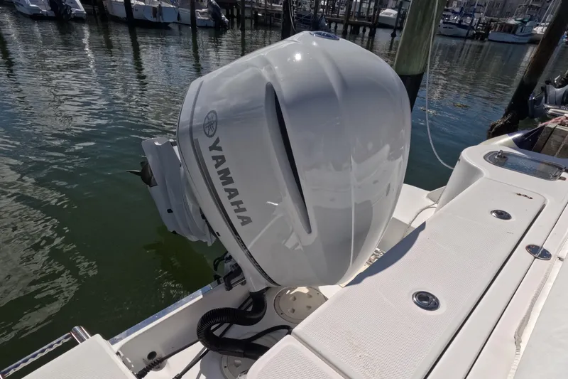 Slide: The Image of 2012 Robalo R247 Dual Console with Yamaha outboard engine at marina. - 42