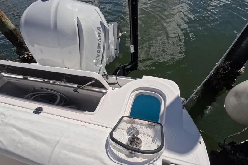 Slide: The Image of 2012 Robalo R247 Dual Console boat with Yamaha outboard engine, docked by the water. - 44