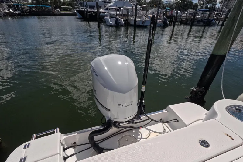 Slide: The Image of 2012 Robalo R247 Dual Console boat with outboard motor at marina dock. - 45