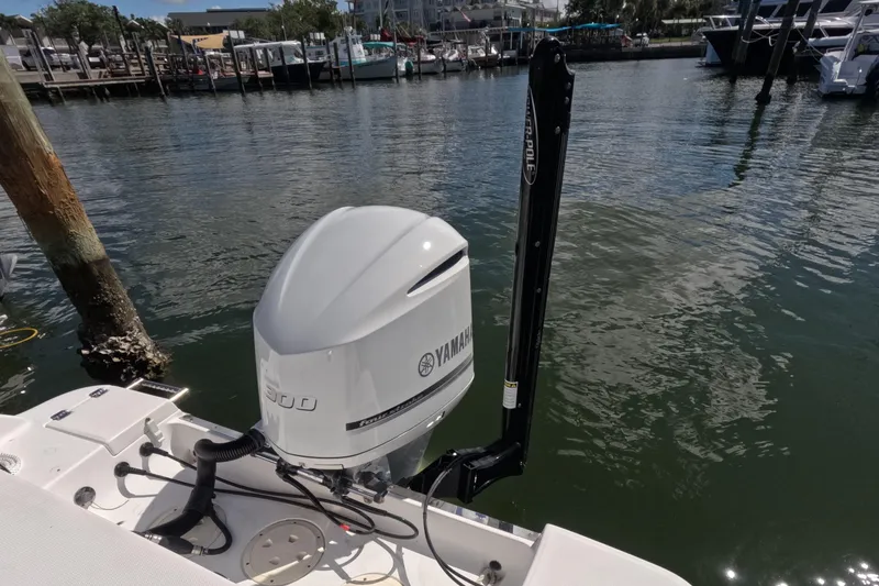 Slide: The Image of 2012 Robalo R247 Dual Console with Yamaha outboard engine docked by the water. - 46