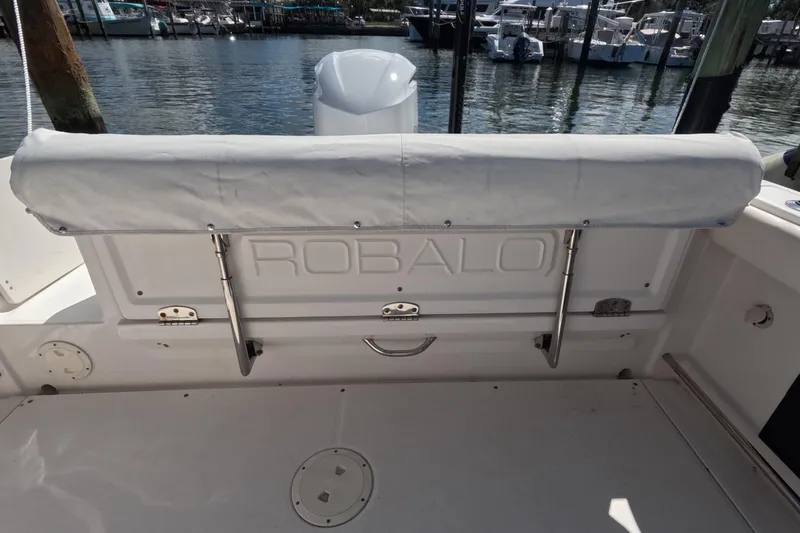 Slide: The Image of 2012 Robalo R247 Dual Console boat interior with seating and marina view. - 48