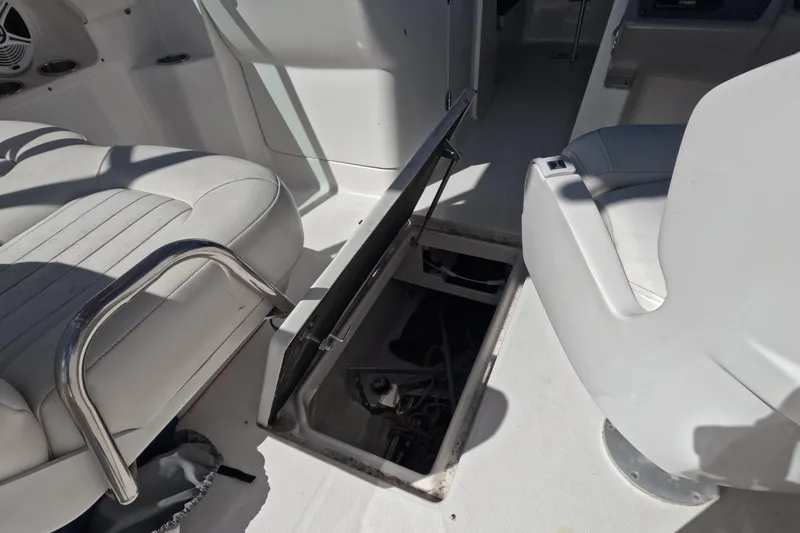 Slide: The Image of 2012 Robalo R247 Dual Console boat interior with open storage compartment. - 50