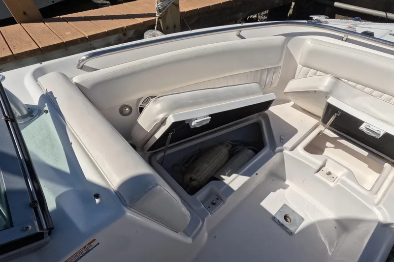 Slide: The Image of 2012 Robalo R247 Dual Console boat interior with open storage compartments. - 52