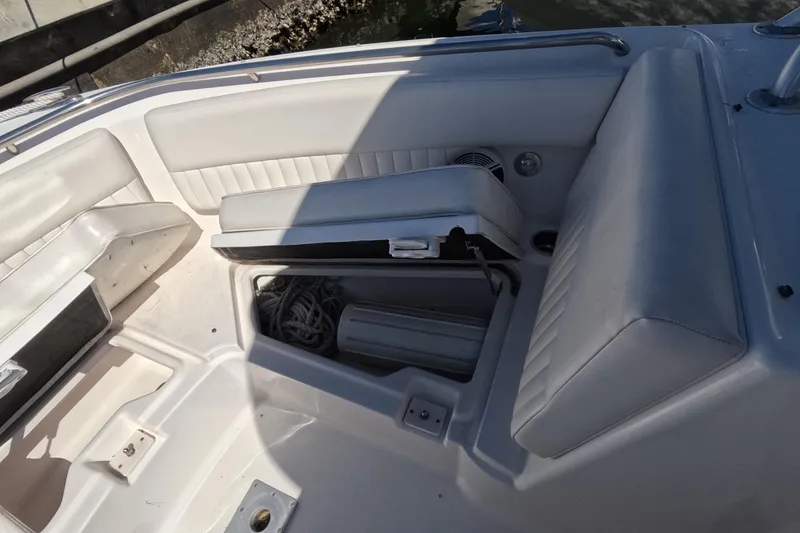 Slide: The Image of 2012 Robalo R247 Dual Console boat interior with open storage compartment. - 54