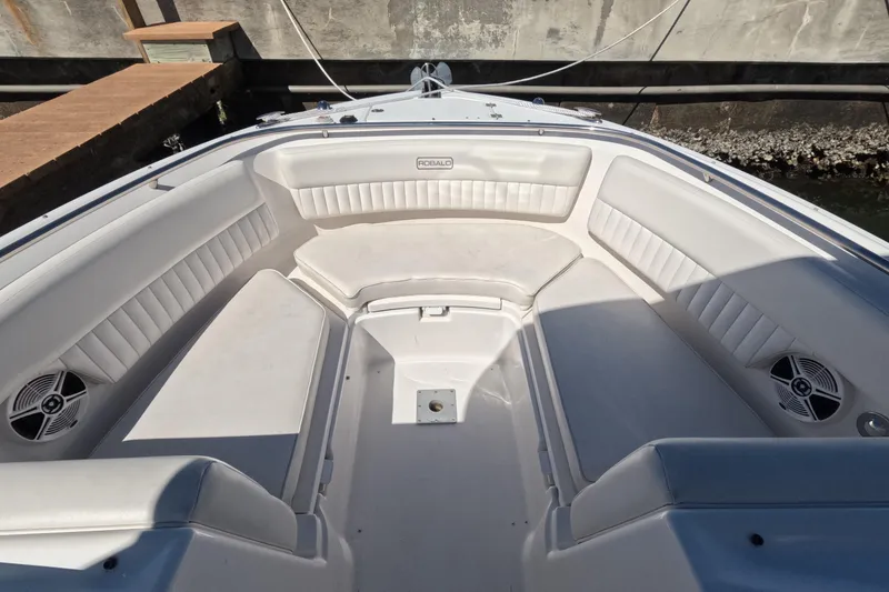 Slide: The Image of 2012 Robalo R247 Dual Console boat interior with spacious seating and speakers. - 55