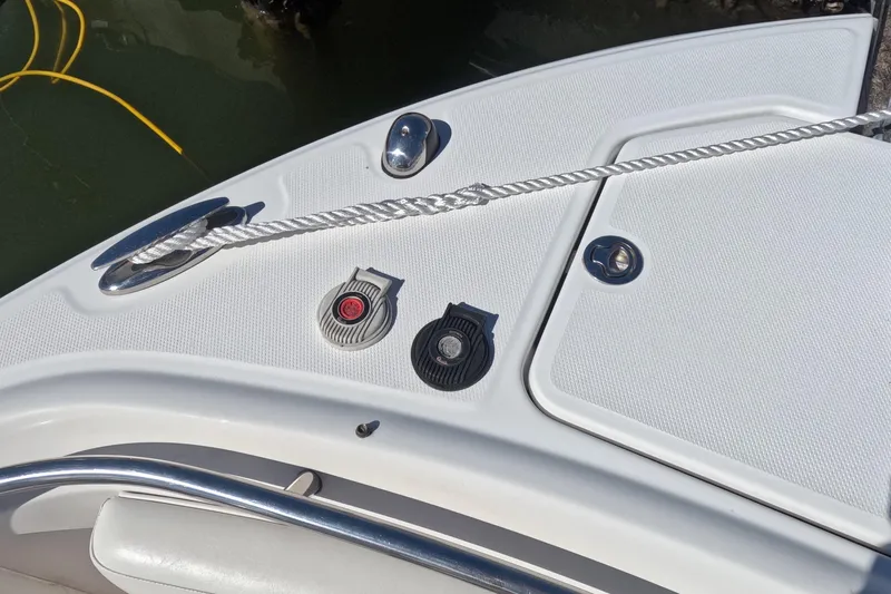 Slide: The Image of 2012 Robalo R247 Dual Console boat deck with cleat and rope details. - 56