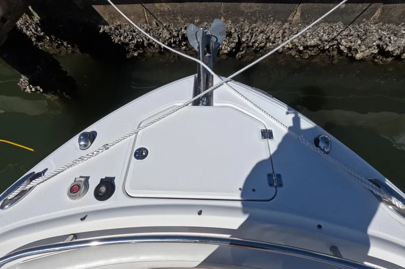 Slide: The Image of Bow of 2012 Robalo R247 Dual Console boat with anchor and ropes. - 57