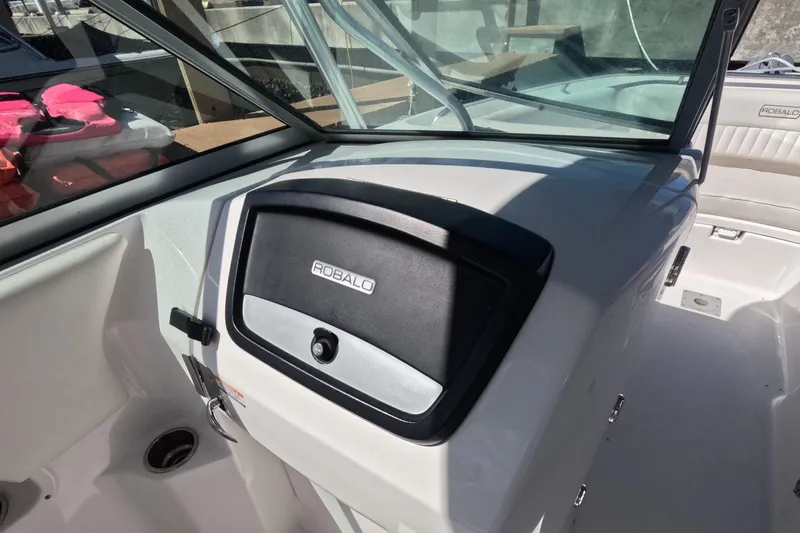Slide: The Image of 2012 Robalo R247 Dual Console boat interior with dashboard and seating area. - 65