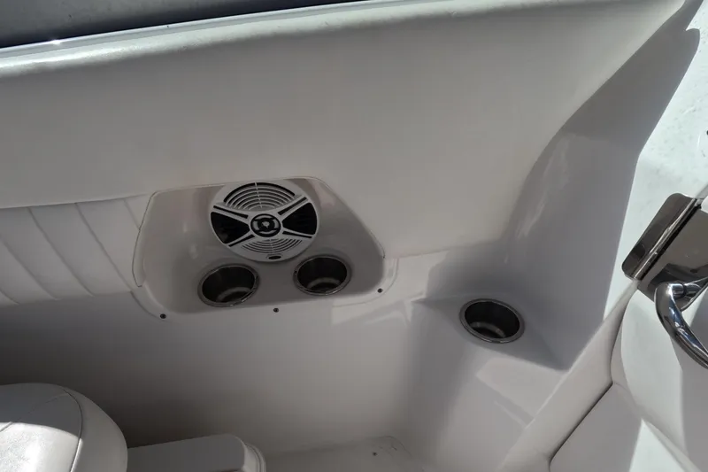 Slide: The Image of Interior of 2012 Robalo R247 Dual Console boat with speaker and cup holders. - 66