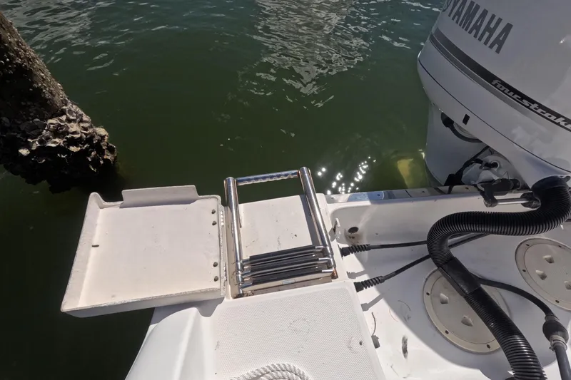 Slide: The Image of 2012 Robalo R247 Dual Console boat with Yamaha engine and swim platform ladder. - 70