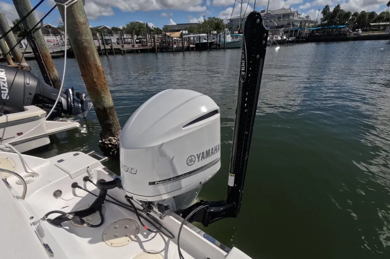 Slide: The Image of 2012 Robalo R247 Dual Console with Yamaha outboard engine docked by the water. - 74