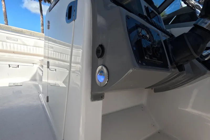 Slide: The Image of 2012 Robalo R247 Dual Console boat interior with control panel and seating. - 79
