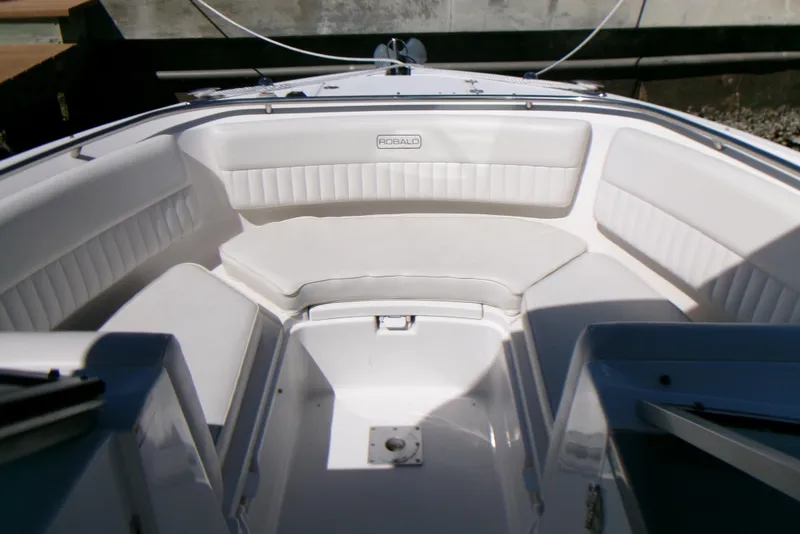Slide: The Image of 2012 Robalo R247 Dual Console boat interior with white seating and sleek design. - 8